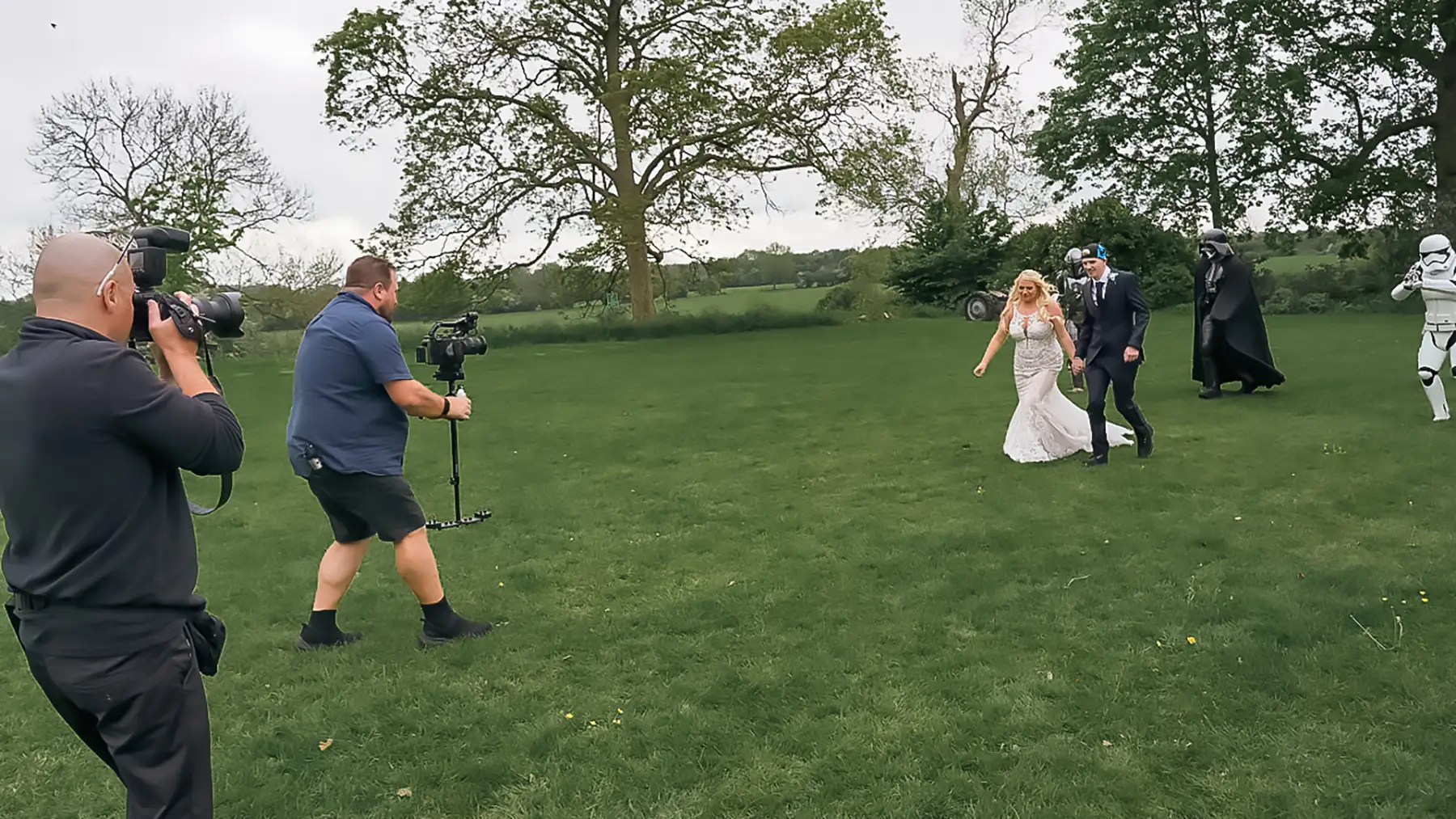 Chris filming while Pete photographs a couple during their wedding day